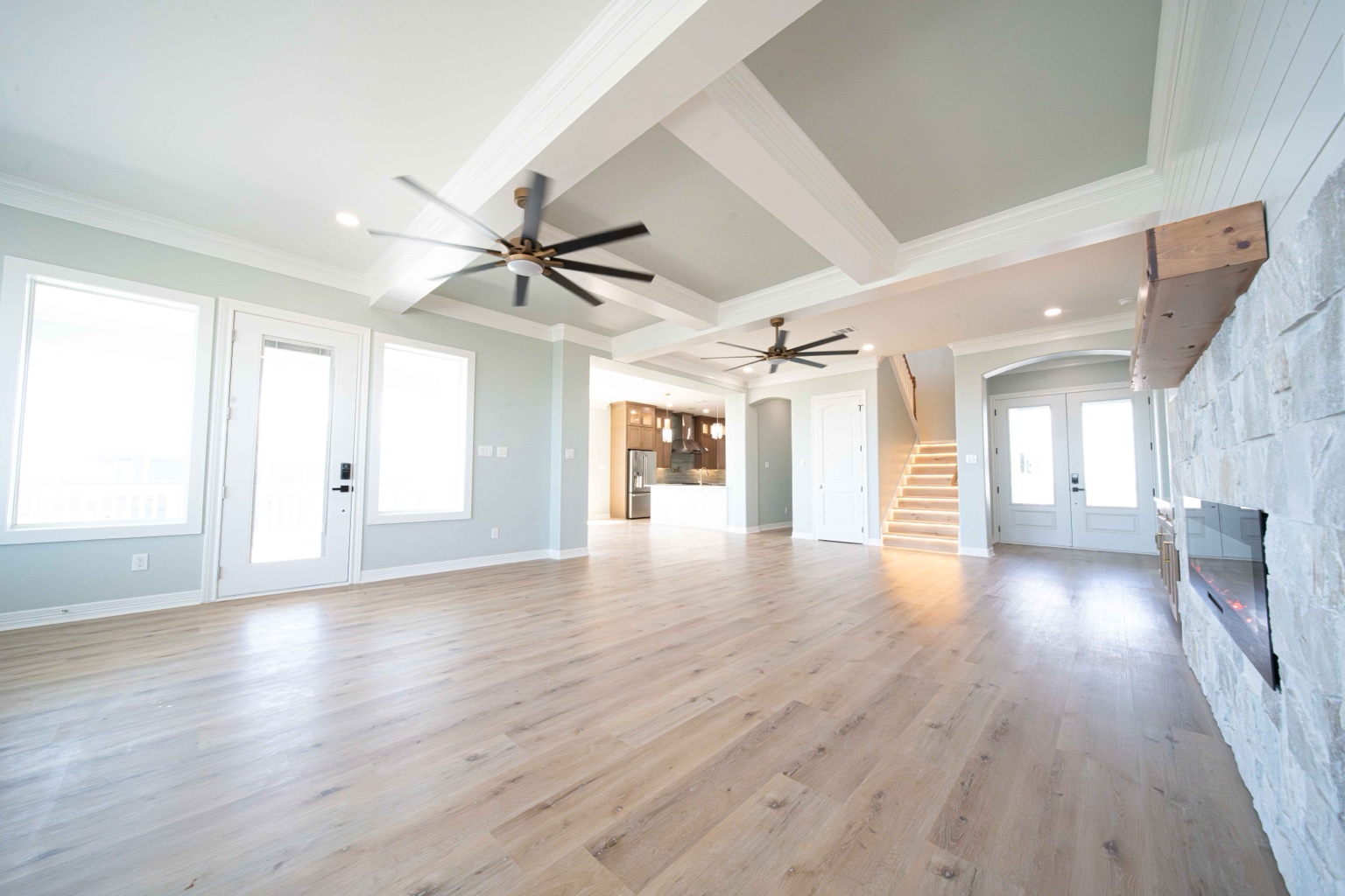 Open living room with tall ceilings and fireplace
